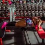 Intense workout session of a female athlete doing push-ups in a gym.