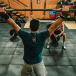 A group of men engaged in a vigorous weightlifting session at a gym.