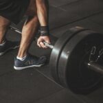 A man lifting a heavy barbell during a gym workout, showcasing strength and fitness.