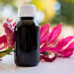 black glass bottle on white table