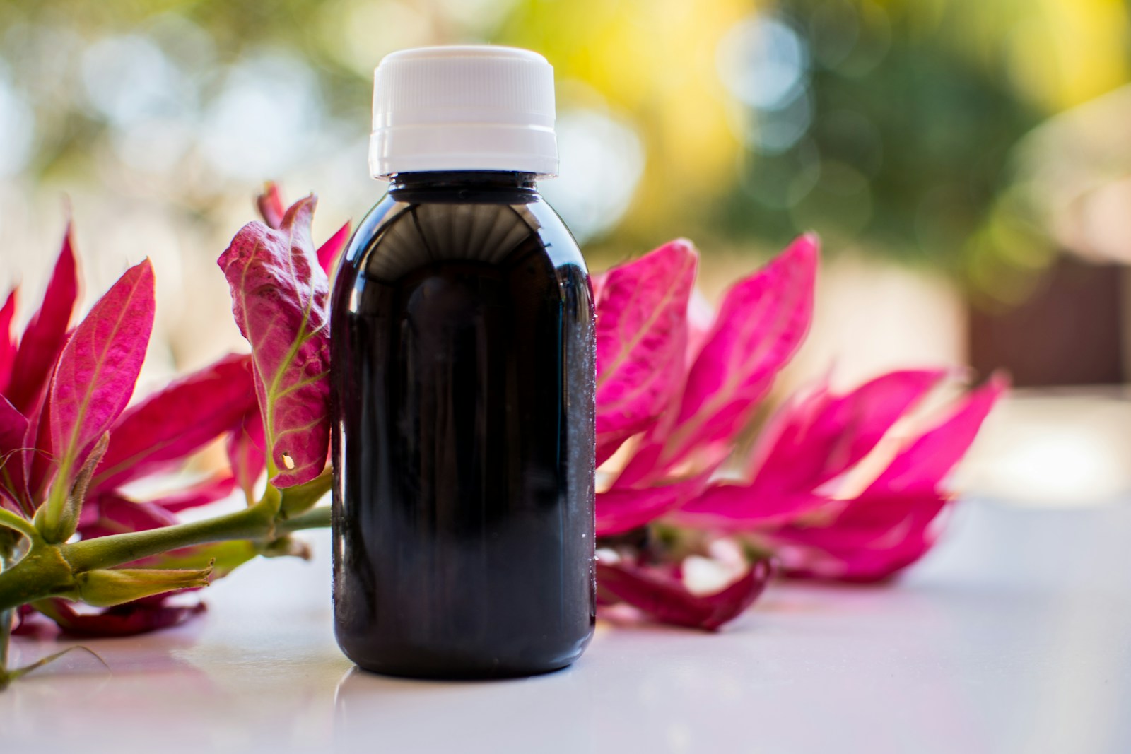 black glass bottle on white table