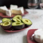 sliced avocado fruit on white ceramic plate